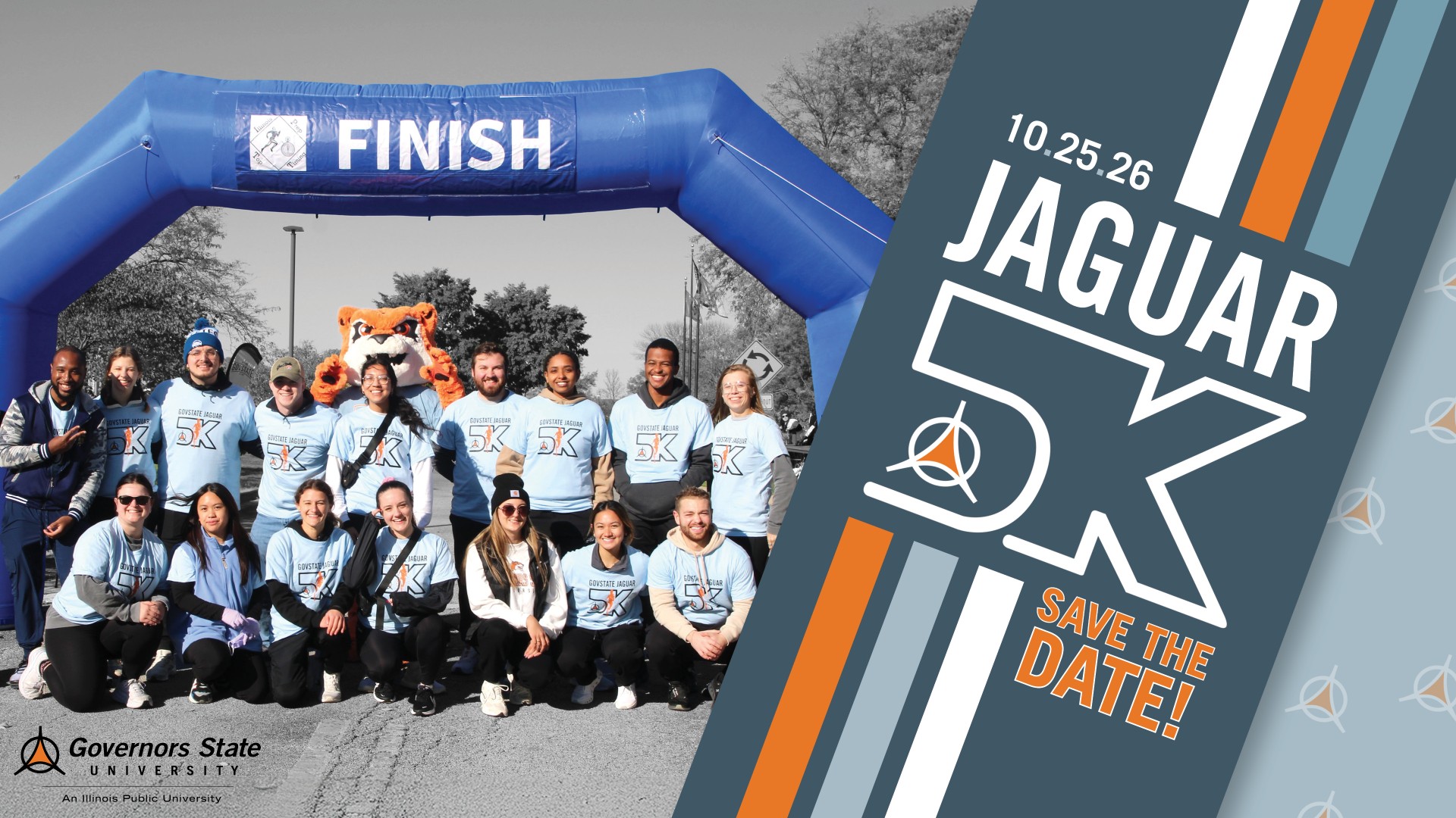 Save the date for the Governors State University Jaguar 5K on October 25, 2026. A group of smiling participants in light blue Govstate Jaguar 5K shirts pose under a blue inflatable finish line arch, joined by the GovState Jaguar mascot. The event graphic features bold orange and slate blue branding.